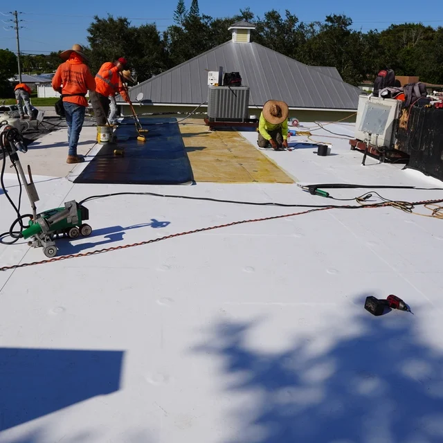 Skilled commercial roofing crew installing durable roof on Florida business property.